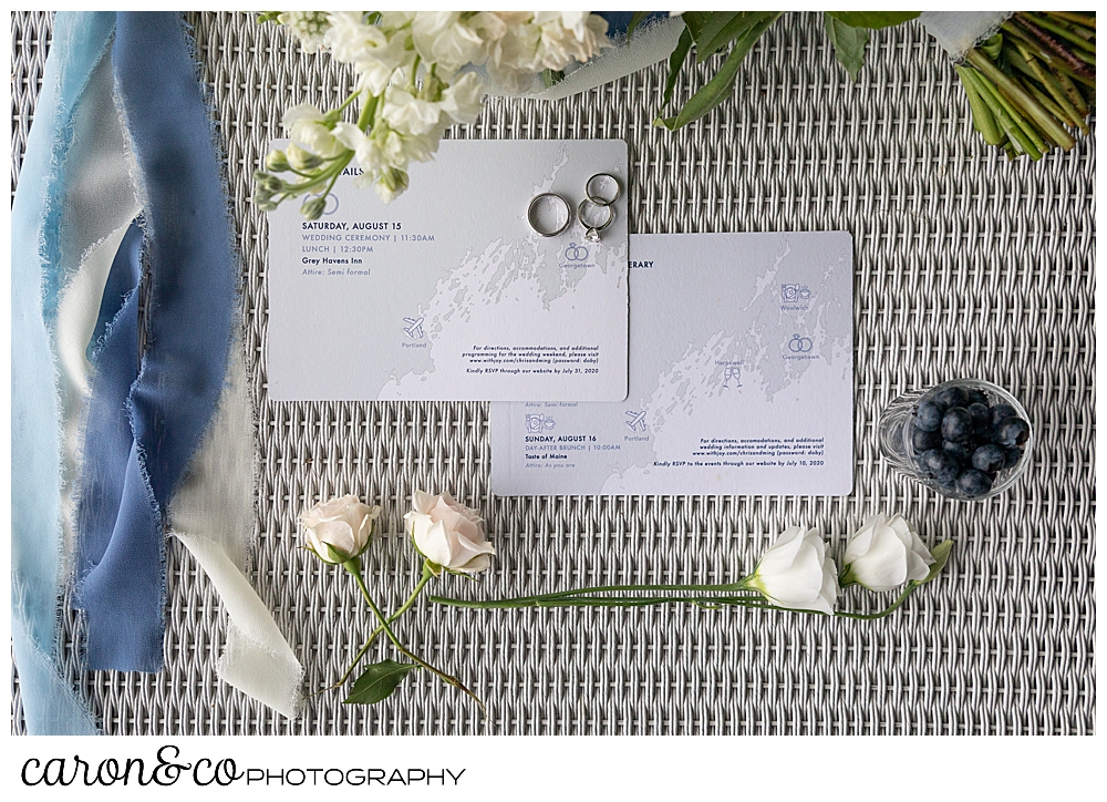 wedding day details with bouquet, paper suite, and rings