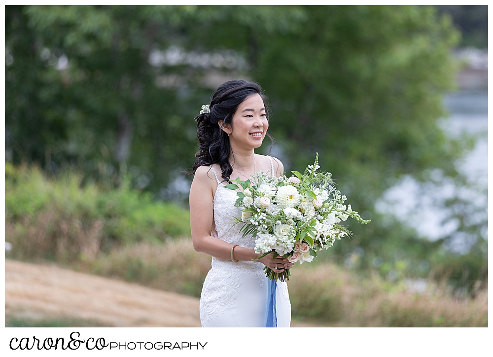 bride smiling during wedding day first look at Grey Havens Inn wedding, Georgetown Maine