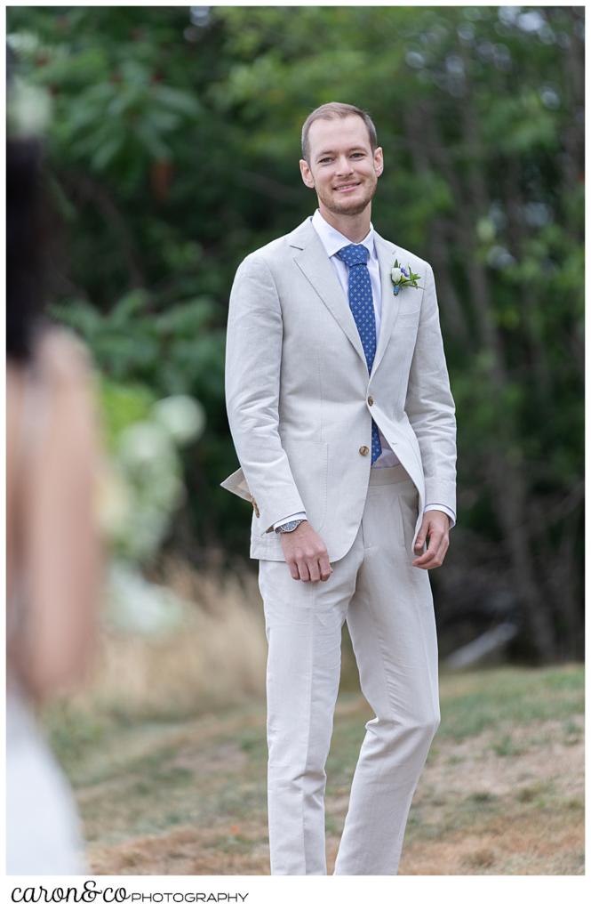 groom turning around to see his bride during a wedding day first look at a Grey Havens wedding, Georgetown Maine