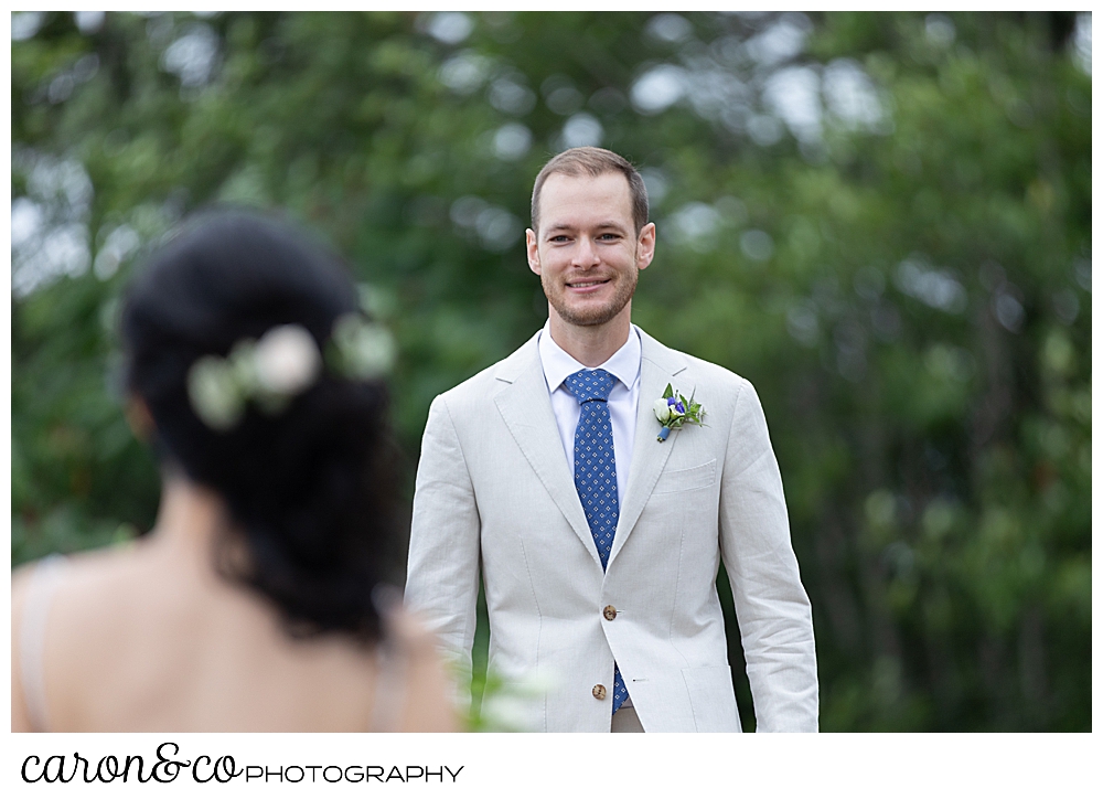 groom walking towards bride during wedding day first look at Grey Havens Inn wedding, Georgetown Maine