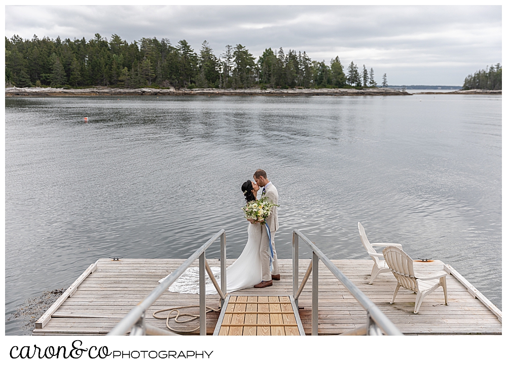 bride and groom kissing on a dock at Grey Havens Inn wedding, Georgetown Maine