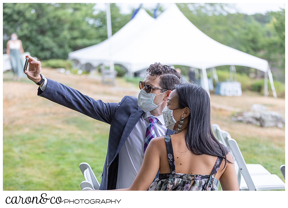 wedding guests taking a selfie, with masks on, before a Grey Havens Inn wedding ceremony, Georgetown Maine