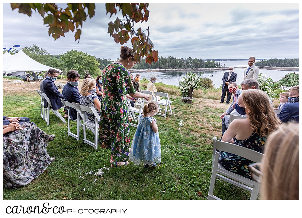 flower girl and her mother walk down the aisle of a Grey Havens Inn wedding ceremony, Georgetown Maine