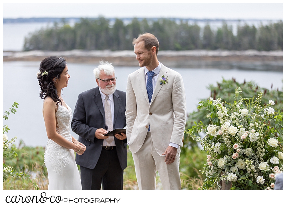 bride and groom on the lawn at their Grey Havens Inn wedding ceremony, Georgetown Maine