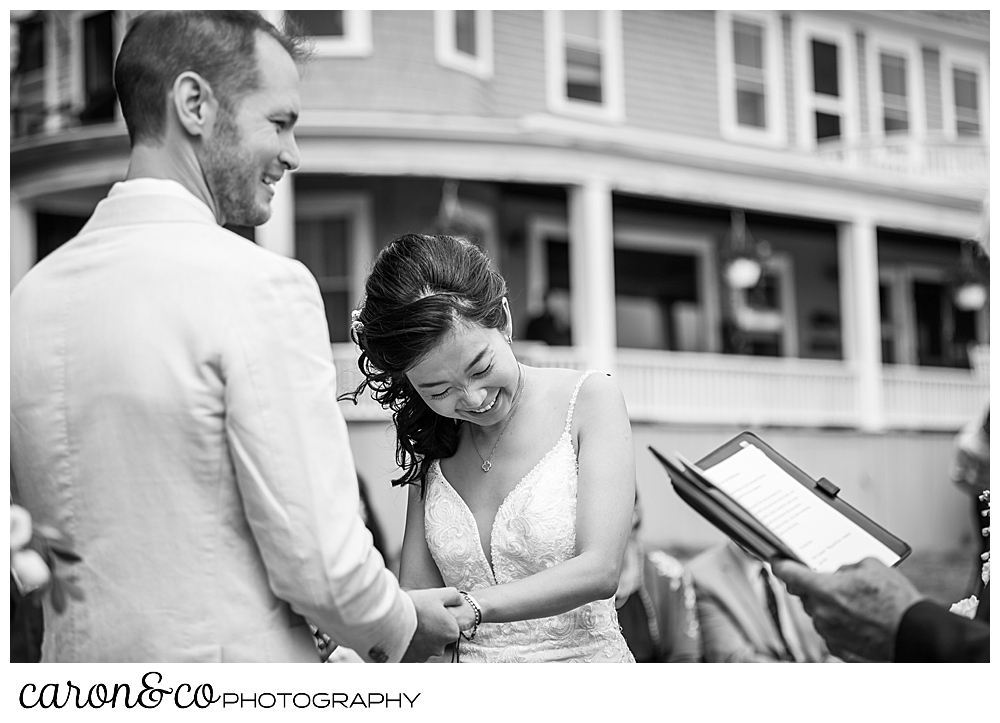 black and white photo of a bride laughing during her Grey Havens Inn wedding, Georgetown Maine