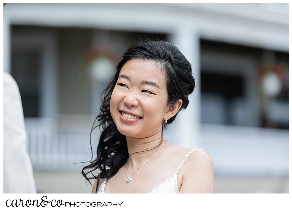 bride smiling during her Grey Havens Inn wedding ceremony on the lawn at Georgetown Maine