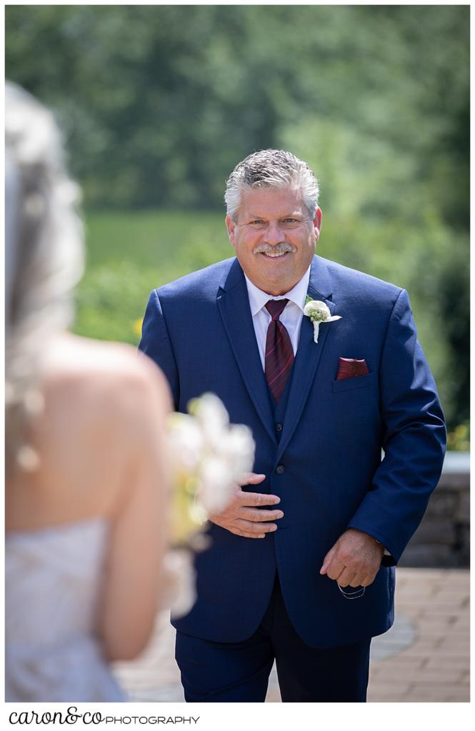 groom walks toward his bride during their wedding day first look