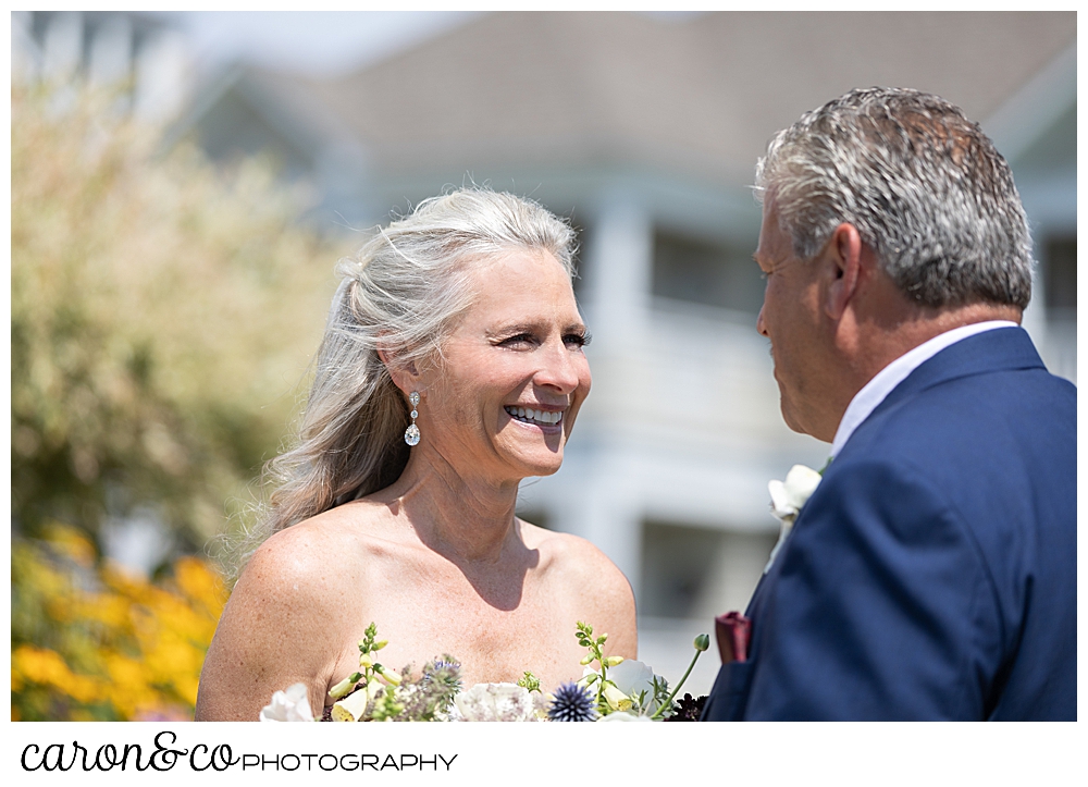 bride smiles at her groom during their first look