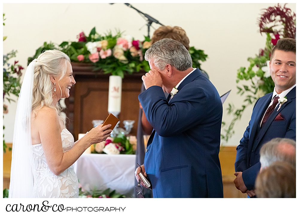 groom wipes his eye during his spurwink church cape elizabeth maine wedding ceremony