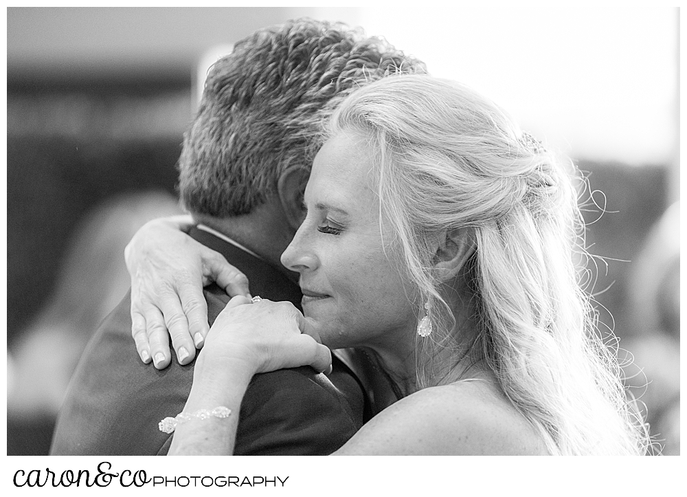 black and white photo of a bride and groom dancing 