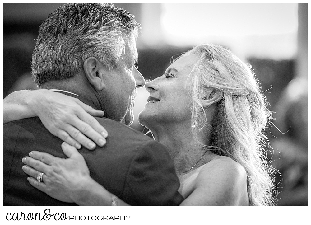 back and white photo of a bride and groom dancing and looking at each other