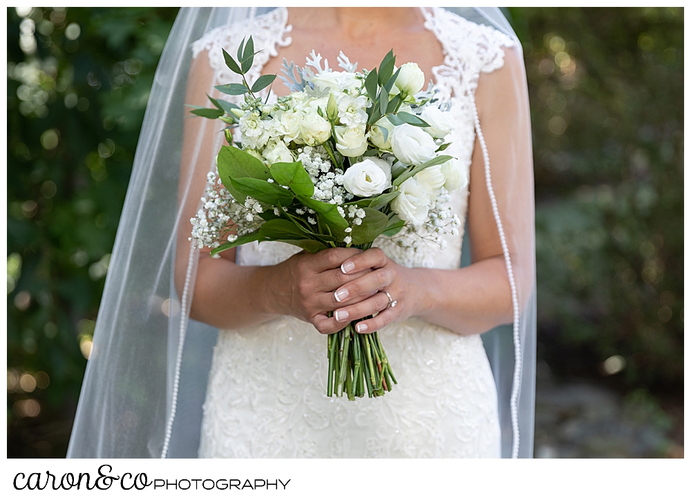 sweet summertime wedding bride holding green and white bridal bouquet