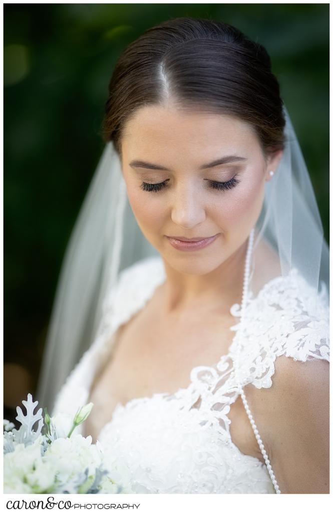 beautiful bridal portrait of a bride in a lacy wedding dress with a veil, with her eyes closed