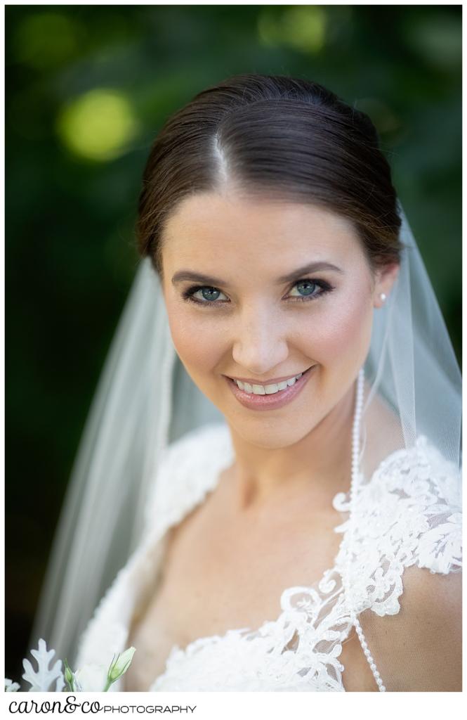 sweet summertime wedding portrait of a beautiful bride, smiling at the camera