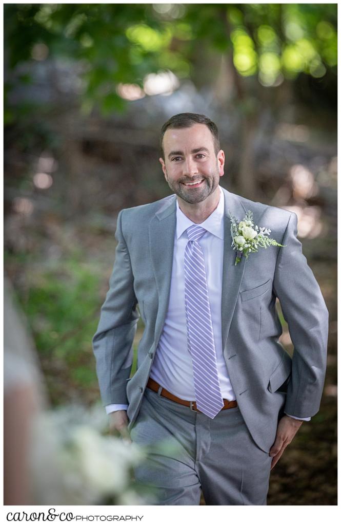 sweet summertime wedding day first look, groom with a big smile walking towards the bride