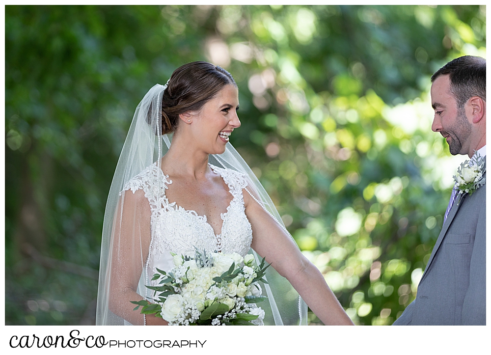 sweet summertime wedding day first look, bride smiles as the groom reaches her