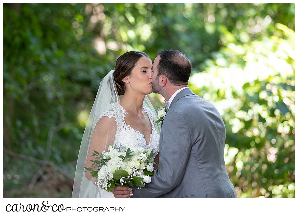 sweet summertime wedding day first look, bride and groom kissing