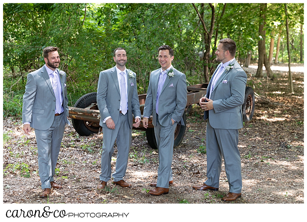 sweet summertime wedding photo of groom and groomsmen laughing