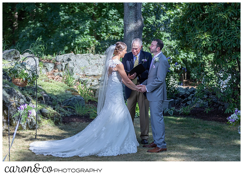 sweet summertime wedding ceremony photo of the bride and groom laughing