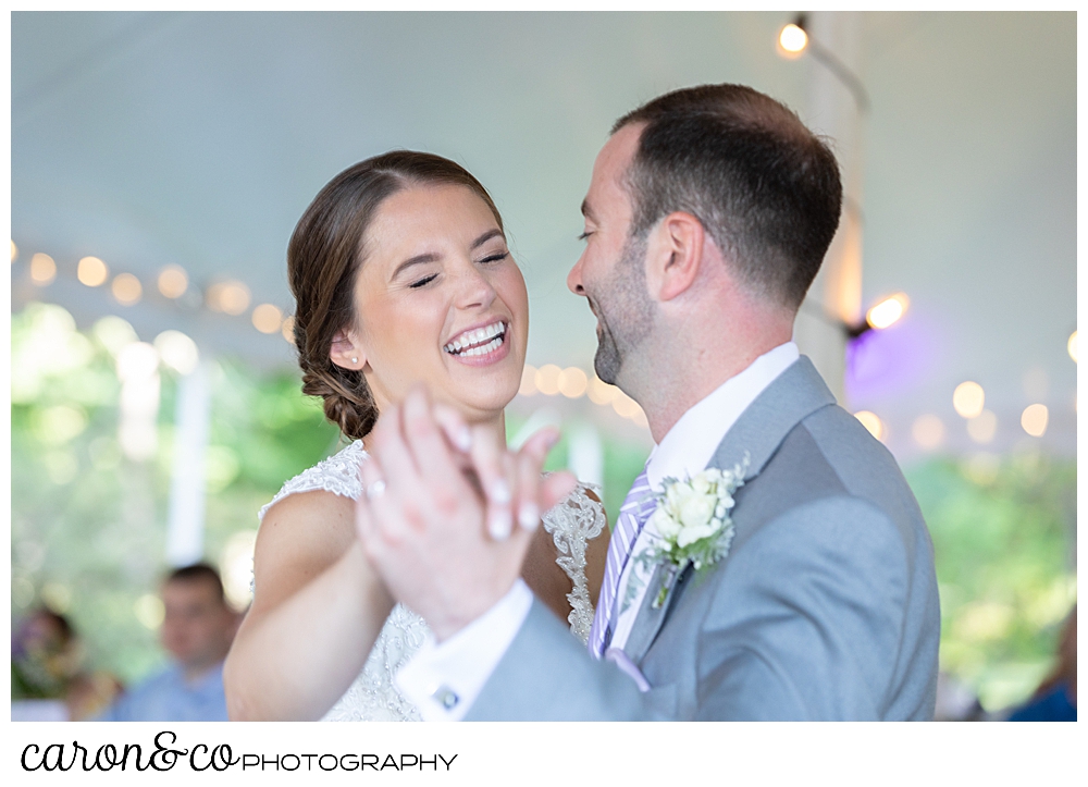 sweet summertime wedding reception photo of the bride and groom smiling during their first dance