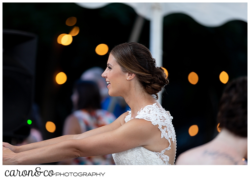 sweet summertime wedding reception photo of the bride dancing 