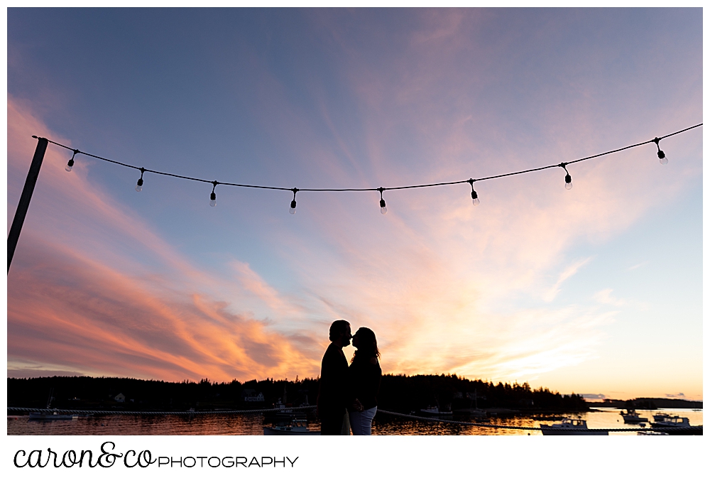 a silhouette of a man and woman kissing during sunset at their Port Clyde Maine engagement photos