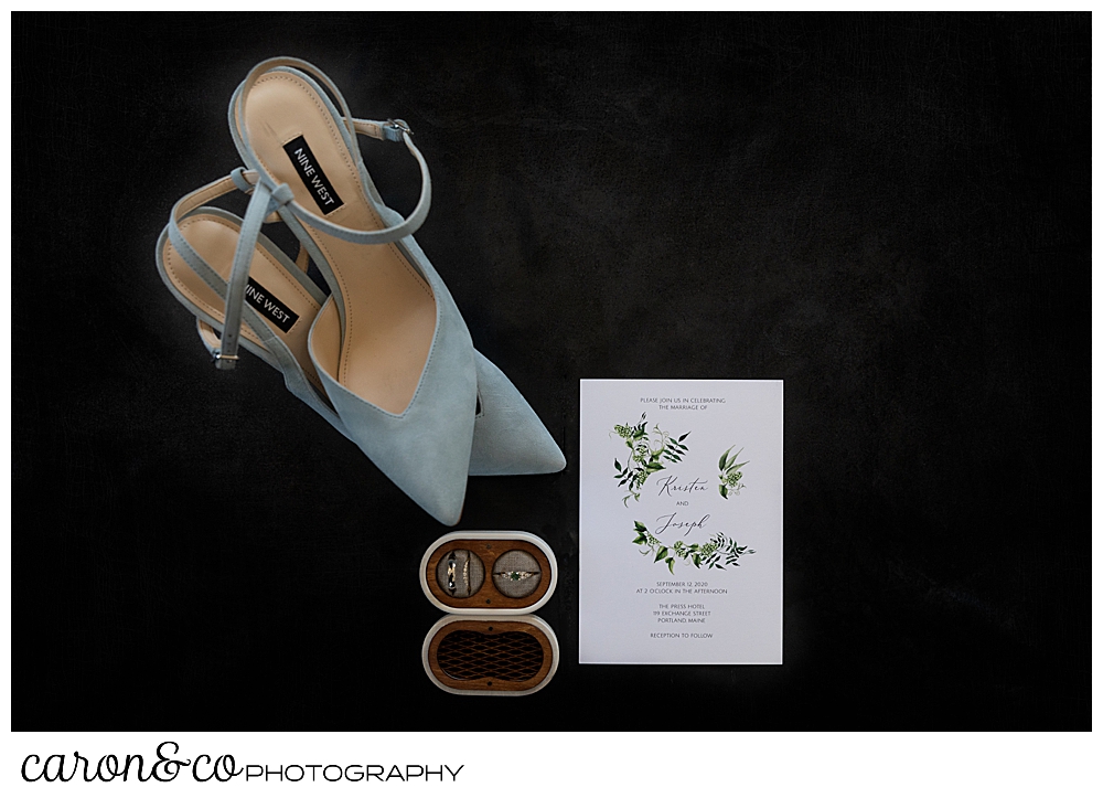 wedding day details, bride's shoes, wedding rings, and invitation at a Portland Press Hotel wedding in Portland Maine