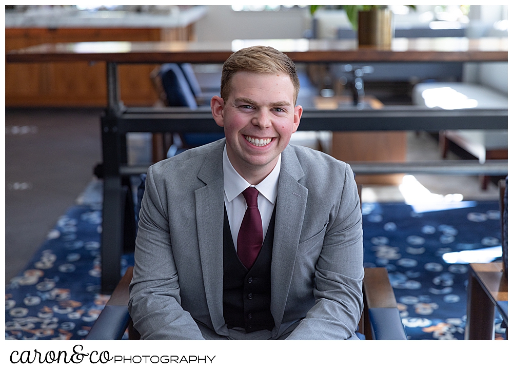 a man sitting in a chair smiles at the camera