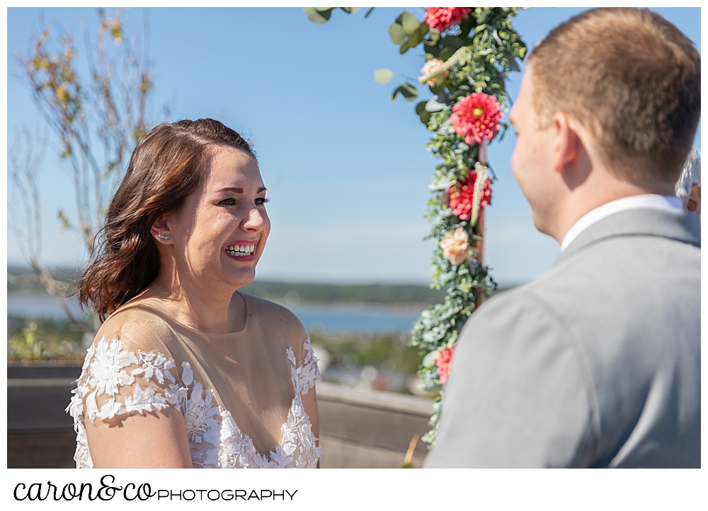 a bride smiles at her groom at a Portland Press Hotel wedding ceremony