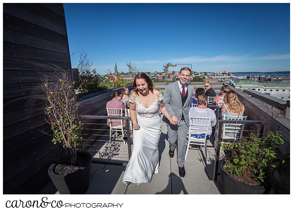 bride and groom during their recessional at their Portland Press Hotel wedding ceremony