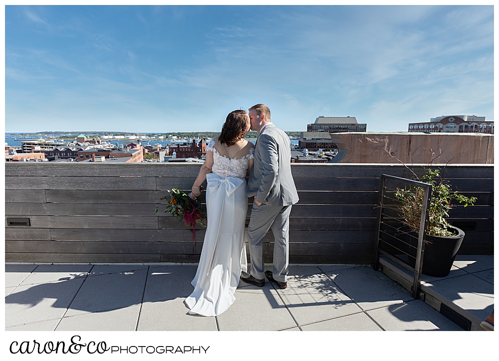 a bride and groom kiss on the rooftop of their Portland Press Hotel wedding