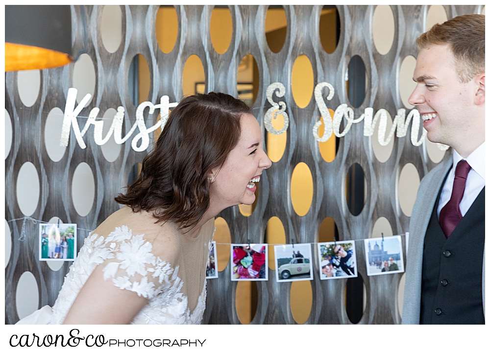 a bride and groom laughing together during their cocktail party