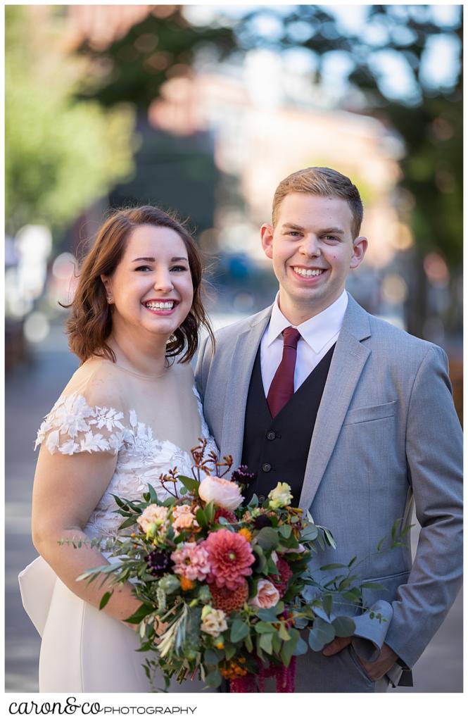 bride and groom standing together, looking at the camera