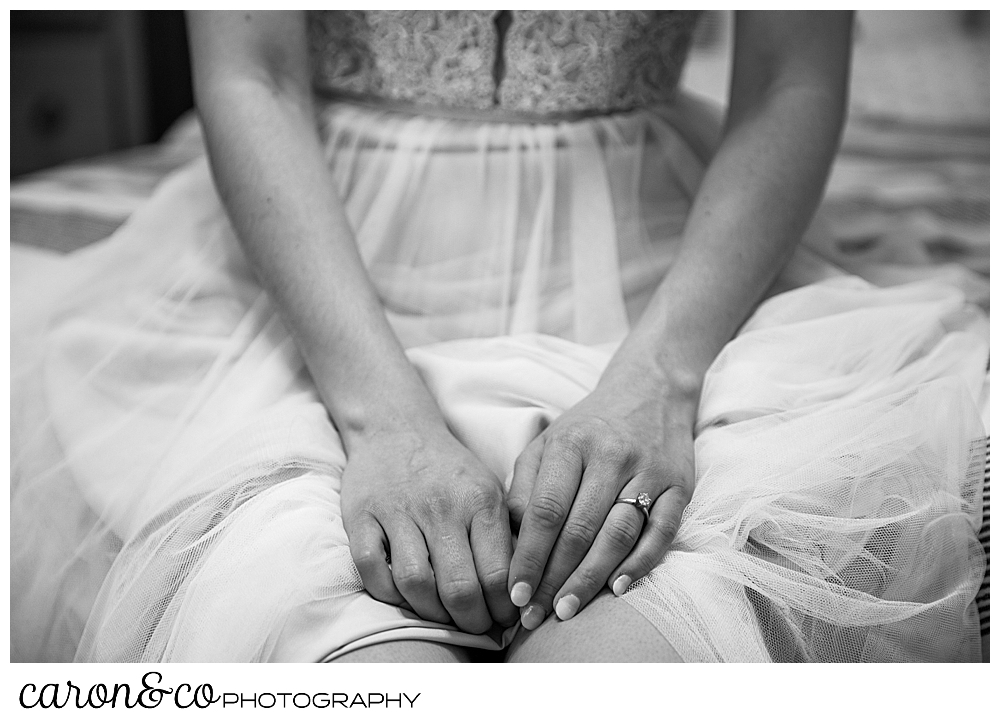 black and white photo of a bride sitting with her hands in her lap, at her sweet Portland Maine elopement