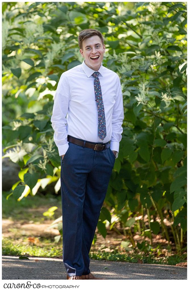 a groom turns around during a wedding day first look 