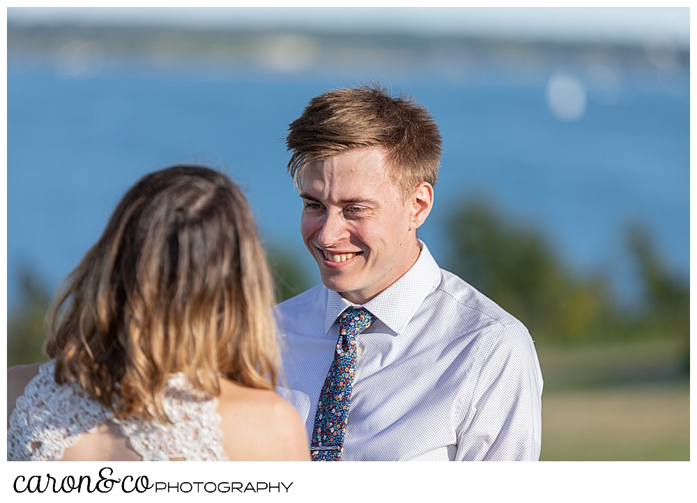 groom smiling at his bride during their sweet Portland Maine elopement ceremony on the Eastern Promenade