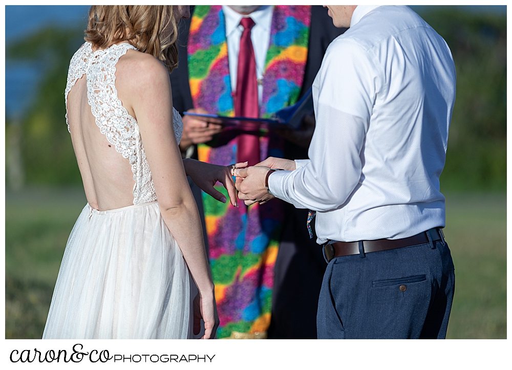 bride and groom standing before their ceremony officiant, during their sweet Portland Maine elopement ceremony