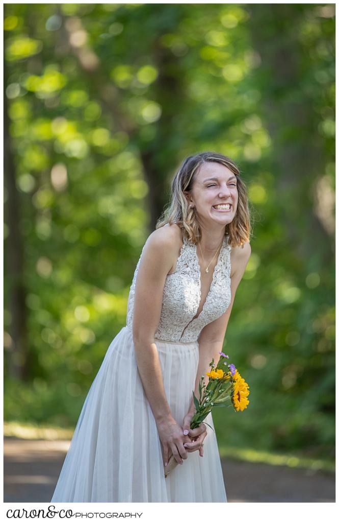 bride leaning forward and smiling during her wedding day first look