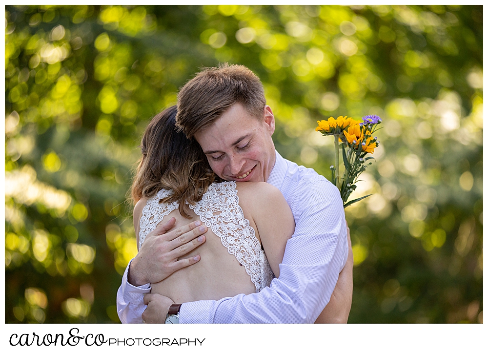 bride and groom hugging each other during their wedding day first look