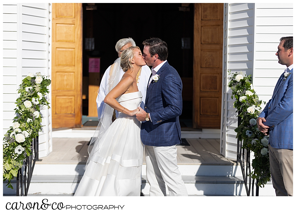 Bride and groom's first kiss at Our Lady Queen of Peace Catholic Church, Boothbay Harbor, Maine