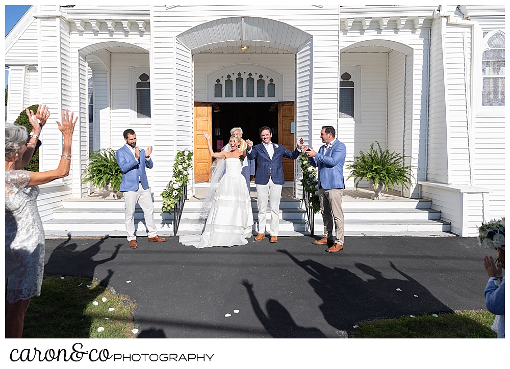 A bride and groom during the recessional at Our Lady Queen of Peace, Boothbay Harbor, Maine wedding