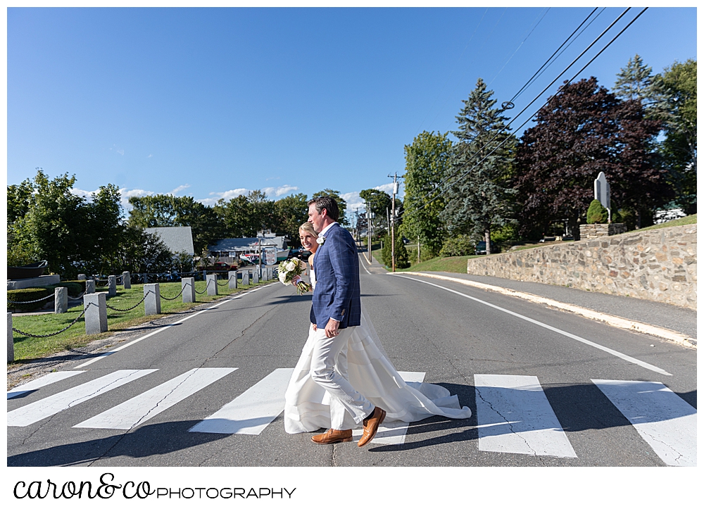 A bride and groom cross the street during their timeless Boothbay Harbor wedding, Boothbay Harbor, Maine