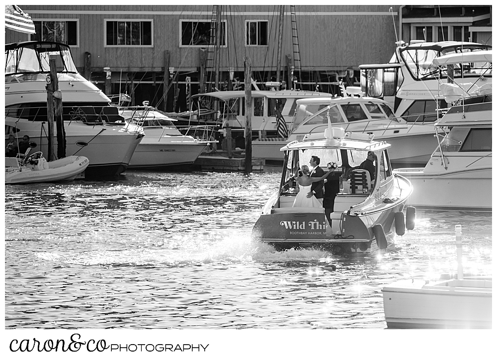 black and white photo of a bride and groom on the back of a Hinckley Yachts Picnic boat in Boothbay Harbor, timeless Boothbay Harbor wedding