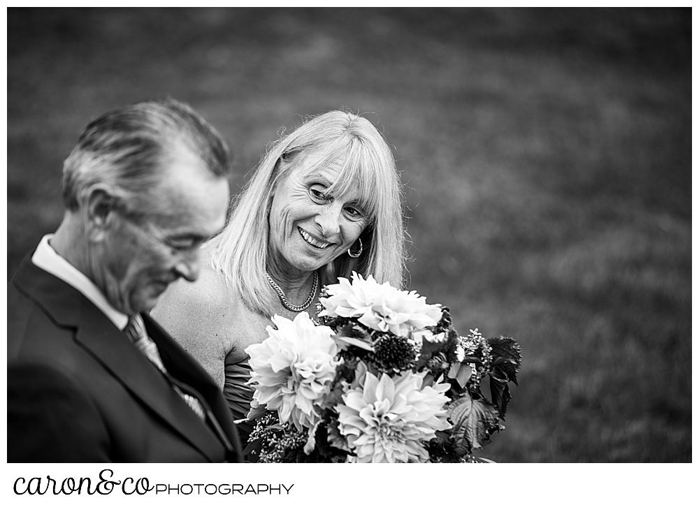 black and white photo of the mother of the bride, looking at the father of the bride