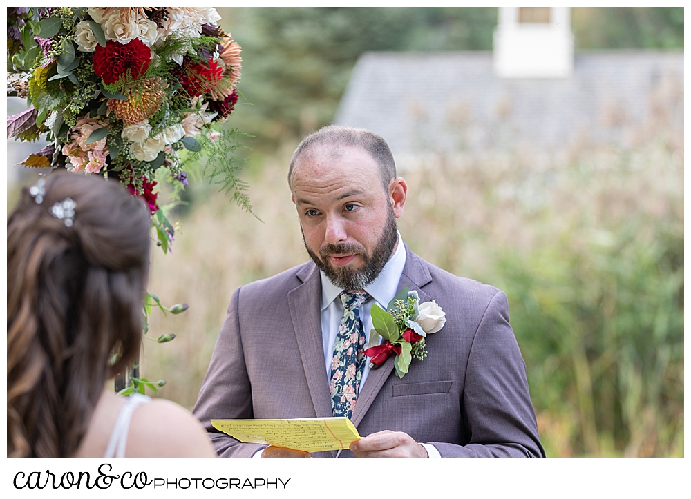 a groom reads his vows to his bride at their charming Kennebunkport Maine wedding ceremony