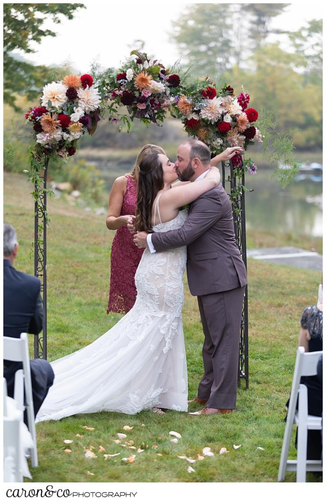 bride and groom's first kiss at their charming Kennebunkport Maine wedding ceremony