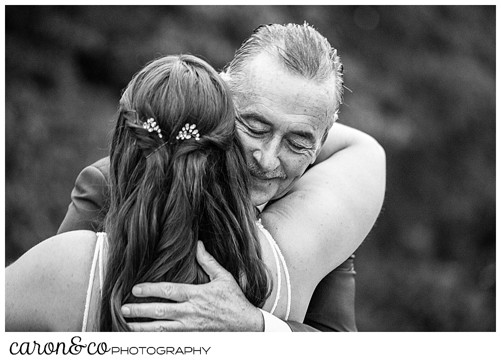 black and white photo of a father and daughter hugging