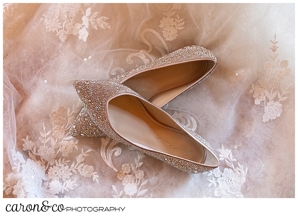 a pair of Betsey Johnson sparkly flats, on the train of a Martina Liana wedding dress