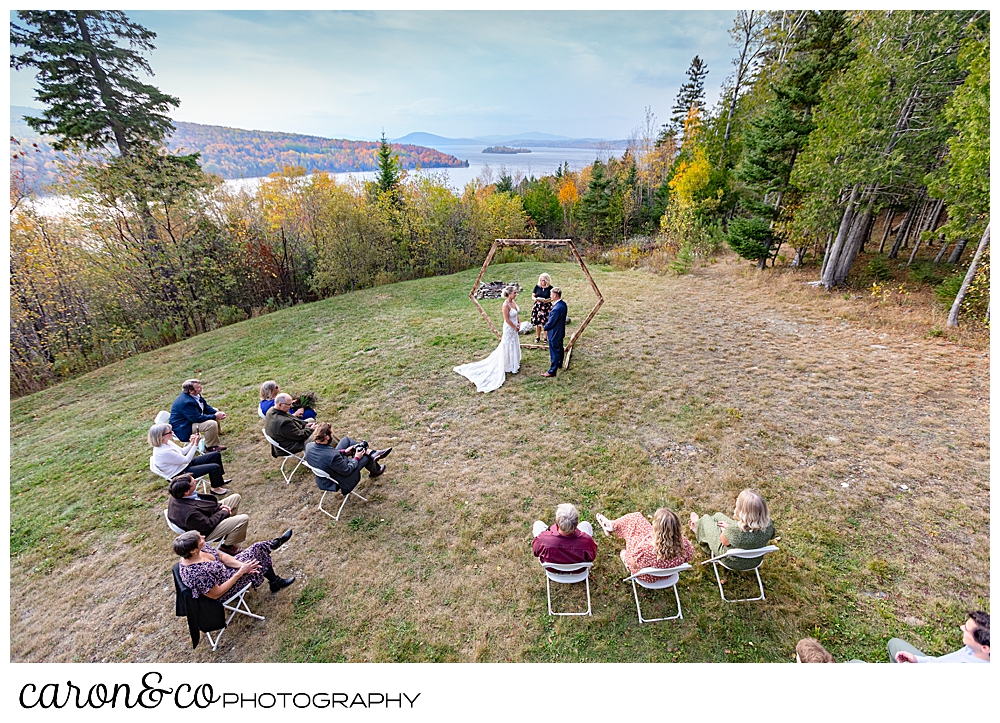 a wide photo of a Rangeley Maine wedding ceremony, with the western mountains in the background