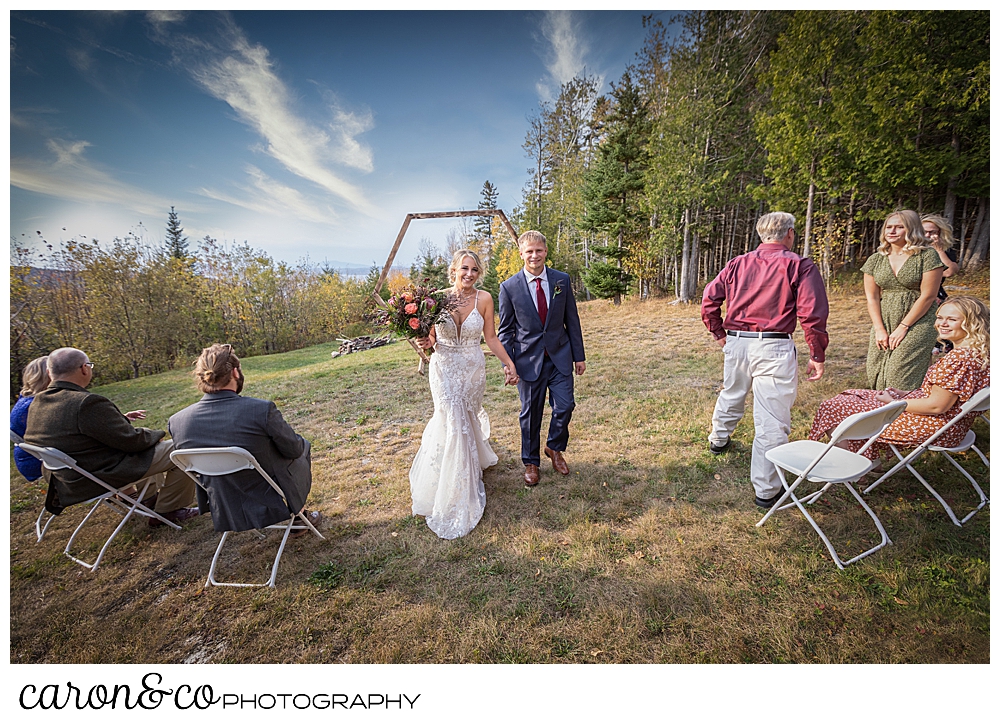 the bride and groom during the recessional at their Rangeley Maine wedding